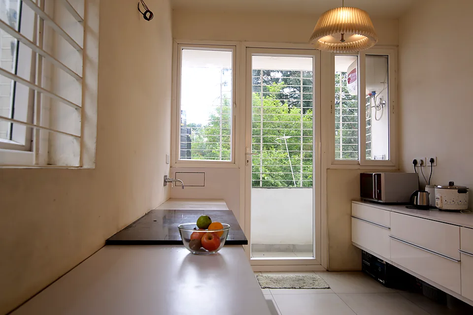 Apartment kitchen with an EUMAX uPVC French door opening onto the balcony